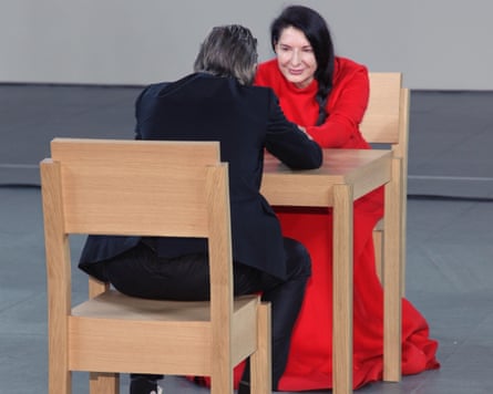 Woman in red dress holding the hands of a man