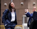 a woman in a suit stands outside