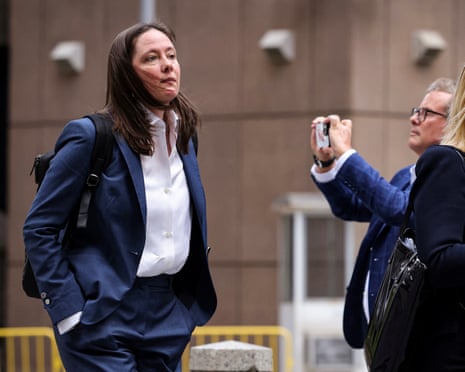 a woman in a suit stands outside