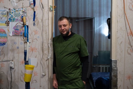 Dr Sholom leans against a doorway