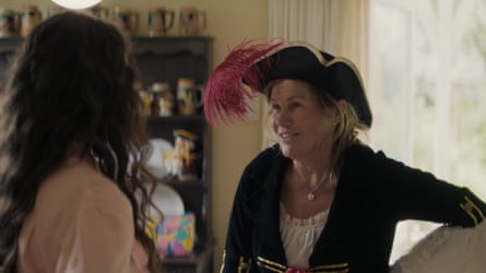 Malcolm as Penny in After the Party standing in a black jacket with a pirate hat on her head
