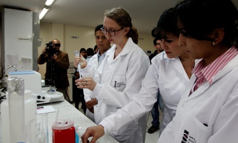 A CDC expert, center, works at a laboratory of the National Institute of Health in Bogota, Colombia.