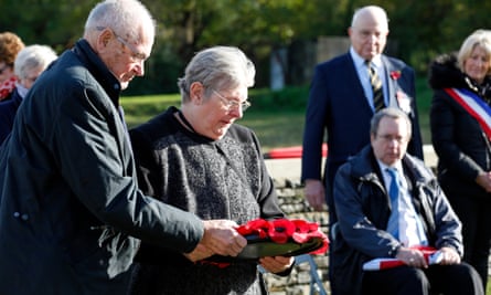 Linda Cook, granddaughter of L/Cpl Frederick Thomas Perkins, laying a poppy wreath during the burial service.