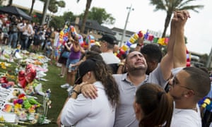 Jose Hernandez, center, joins hands with Victor Baez, right, as they mourn the loss of their friends Amanda Alvear and Mercedez Flores in the Pulse nightclub shooting.