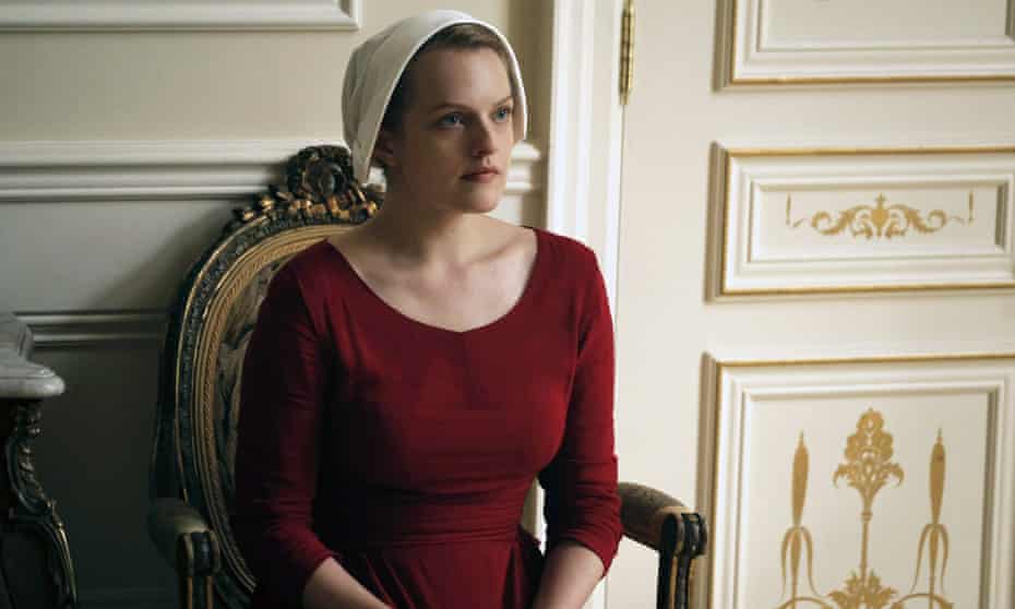Woman in a red dress and white mafia hat sitting