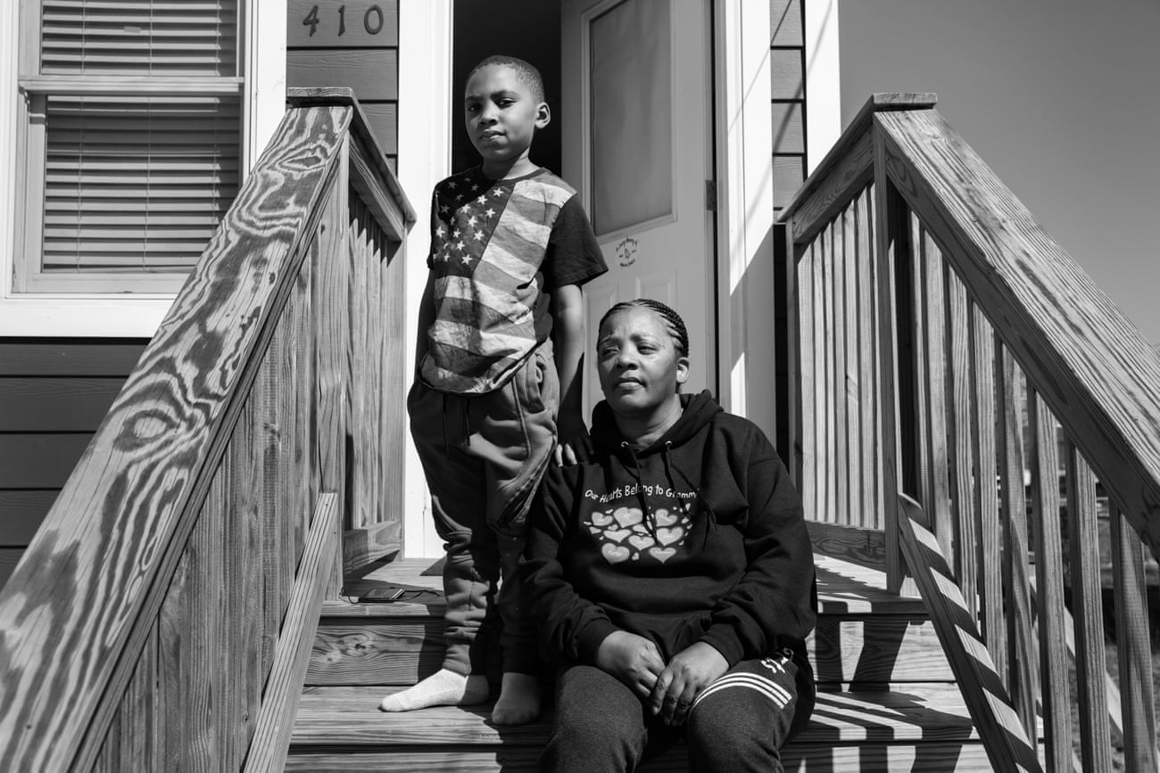 Kimberly White Smalls sits on her front stairs with her grandson Donovan E Smalls, nine, on Beach 43rd Street in the Edgemere neighborhood of Far Rockaway, Queens.