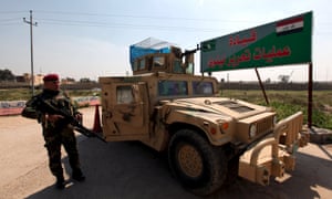 March 13, 2016: Iraqi army members stand guard at Makhmour base, outside Mosul, Iraq.