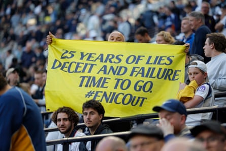 A Spurs fan with a banner protesting against the ownership of the club at half-time against Brighton.