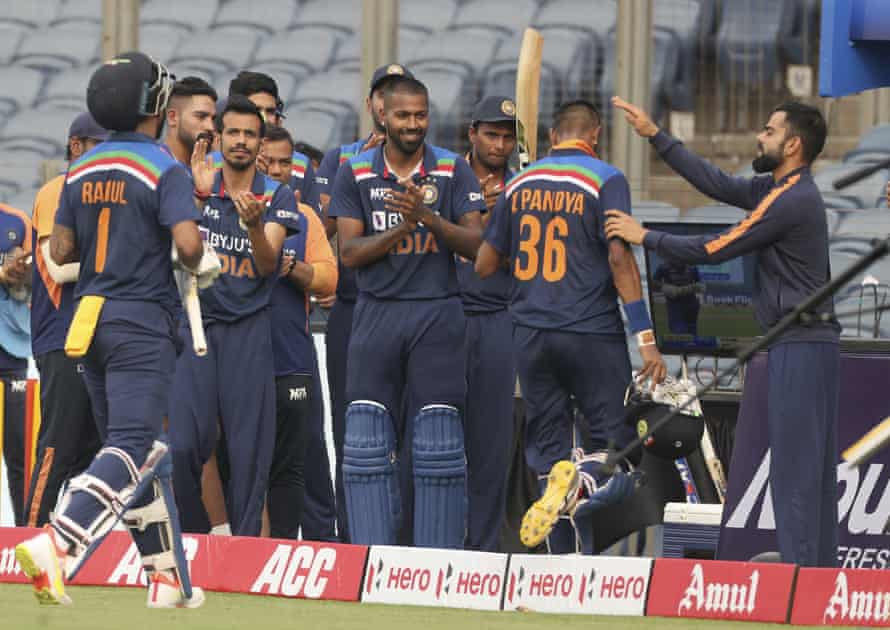 Teammates applaud India’s Krunal Pandya as he walks off.
