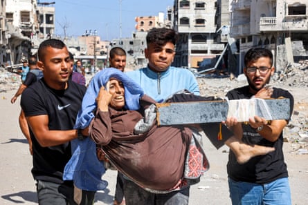 Men carry an injured woman