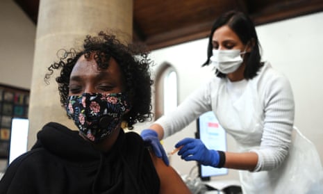 A woman receives the AstraZeneca Covid19 vaccine at an NHS vaccination centre in Ealing. 