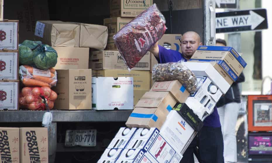 A worker unloads grocery goods in Washington DC.