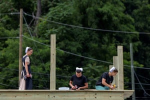 Amish volunteers rebuild a roof in downtown Chimney Rock