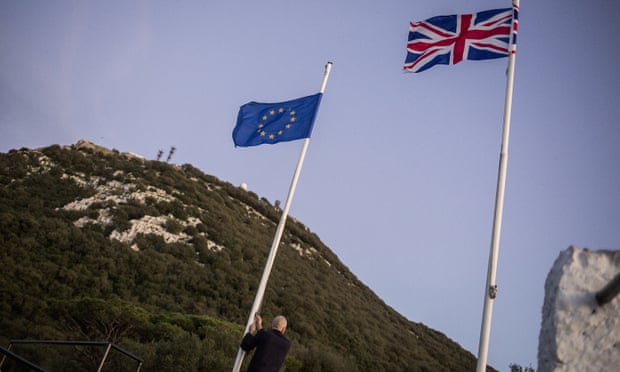 A worker lowering the EU flag in Gibraltar as the UK leaves the bloc.
