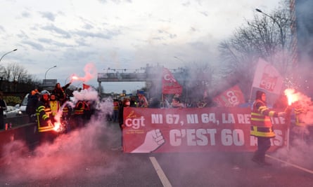 CGT unionists marching with flares and banners on the Paris ring road.