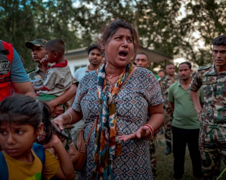 A resident awaits news of missing relatives at a military camp in Trishuli, Nepal