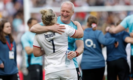 The England head coach, Simon Middleton, hugs captain Marlie Packer after the victory against France.