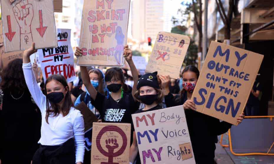 Girls hold up placards at the “March 4 Justice” rally in Sydney