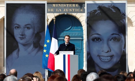 Macron delivers a speech during the ceremony, with large images of Olympe de Gouges and Josephine Baker on the screens behind him