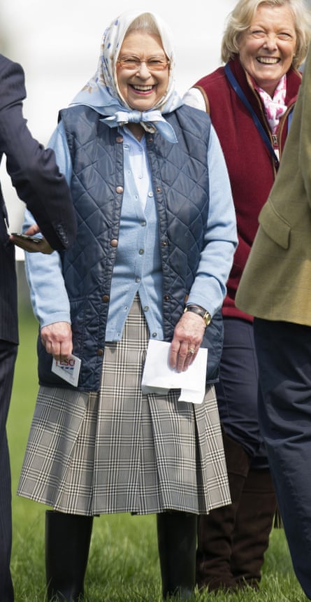 The Queen holds her Tesco gift card in the Windsor castle grounds.
