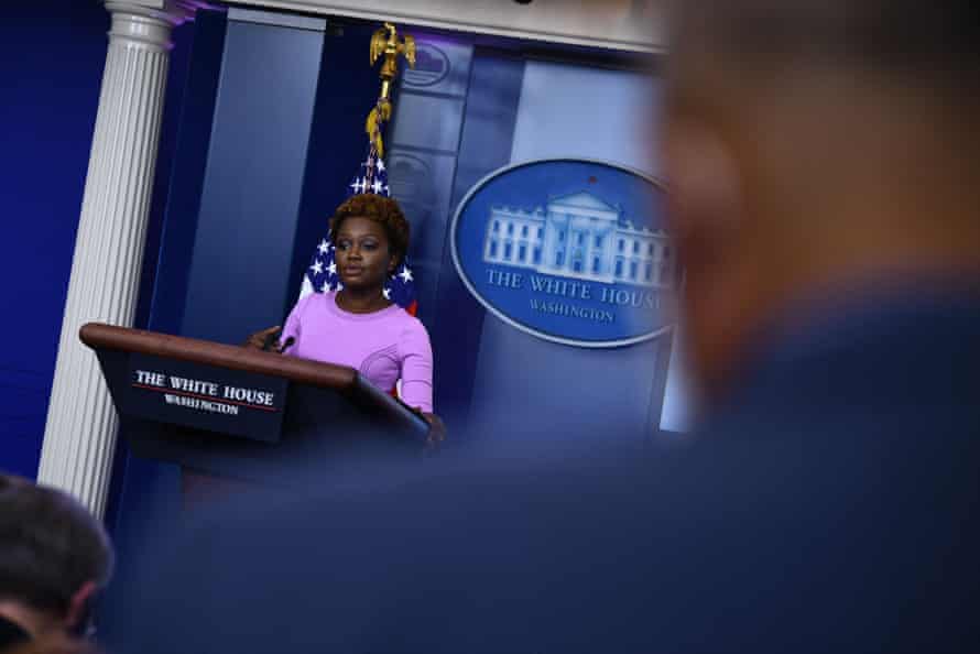 A woman in a purple dress speaks to the media at the White House.