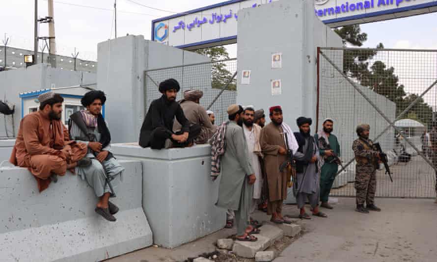 Taliban fighters stand guard outside Hamid Karzai international airport in Kabul on Wednesday