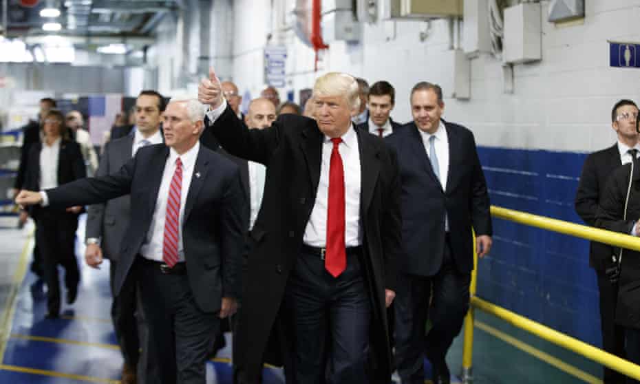 Donald Trump and Mike Pence at a Carrier factory in Indiana. The company has reversed its decision to outsource jobs to Mexico. 