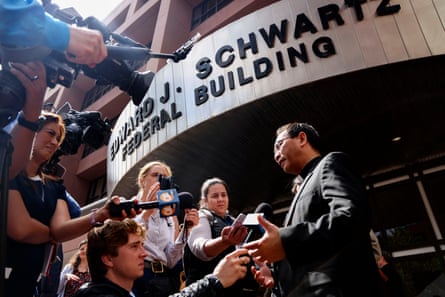 a man speaks to news crews