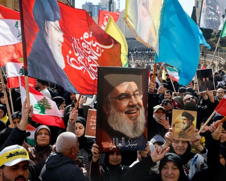 Protesters carry pictures of Hassan Nasrallah in a demonstration