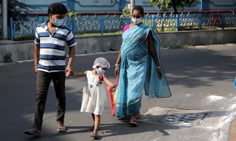 An Indian family visit the National Institute of Cholera and Enteric Diseases during the launch of phase three regulatory trial of Covaxin amid the coronavirus pandemic in Kolkata, India, 2 December 2020.