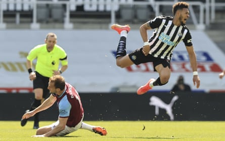 Craig Dawson (left) sends Joelinton flying – after the referee played advantage, the West Ham player received a second yellow card and was sent off.