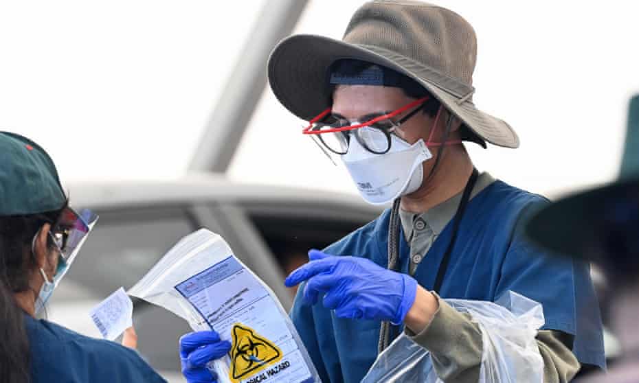 Healthcare workers collecting information from the public at a Covid testing site in Sydney