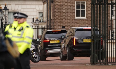 Two black SUVs, one of them believed to be carrying Prince Harry, arrive at Clarence House