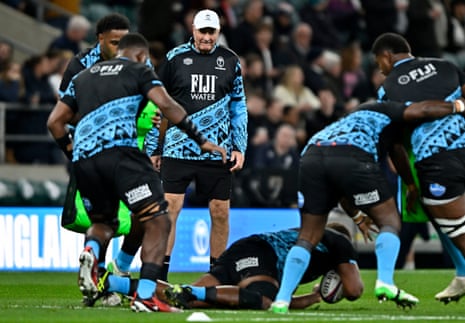 Fiji head coach Mick Byrne watches his players warm up.
