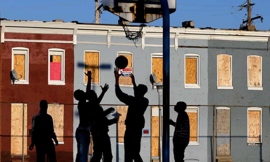 Children play basketball at a park near blighted row houses in Baltimore, Monday, April 1, 2013. Baltimore is far from the worst American city for poverty, but it faces all the problems of cities where vast numbers of the poor now live. The U.S. Census Bureau puts the number of Americans in poverty at levels not seen since the mid-1960s, while $85 billion in federal government spending cuts that began last month are expected to begin squeezing services for the poor nationwide. (AP Photo/Patrick Semansky)