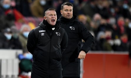 Derby County’s interim manager Wayne Rooney (left) and goalkeeping coach Shay Given watch the goalless draw with Brentford.