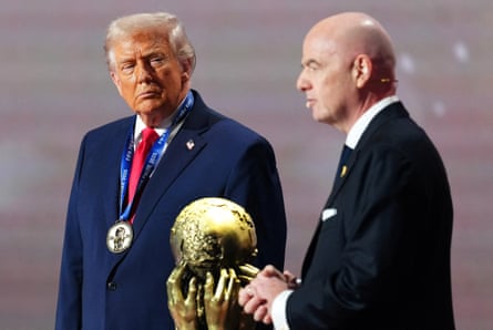 Donald Trump listens to Gianni Infantino speak after being awarded the Fifa peace prize