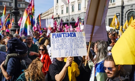 Crowds waved rainbow flags and hold banners in Piazza della Scala, in Milan, on Saturday.