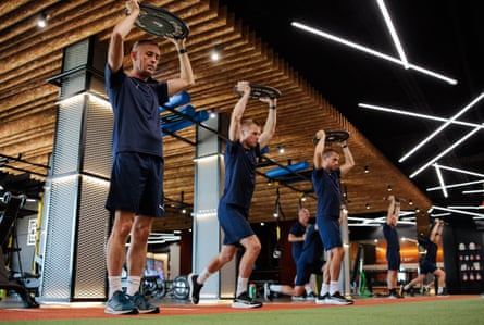 Officials take part in weight training during pre-season training.