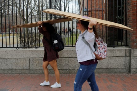 people smile with folded boxes on their heads