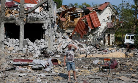A man stands in front of a ruined building that had been hit by a Russian missile in Zatoka, near Odesa, Ukraine