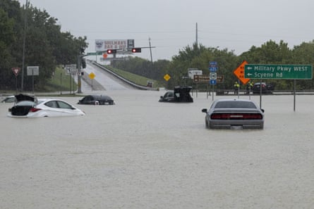 Stalled cars sit abandoned on the flooded Interstate 635 Service Road on Monday in Mesquite, Texas.