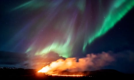 Stunning footage captures northern lights over erupting Iceland volcano – video