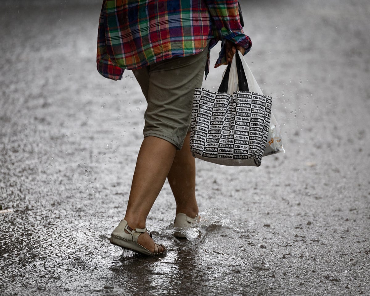 A woman walks during heavy rains in Spain.