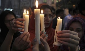 People attend a candlelight vigil for the victims of the Quetta attack in Lahore