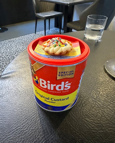 A custard tart sitting on top of a Bird’s custard pot