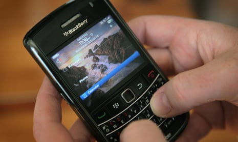 A classic BlackBerry device, with a QWERTY keyboard, is shown.