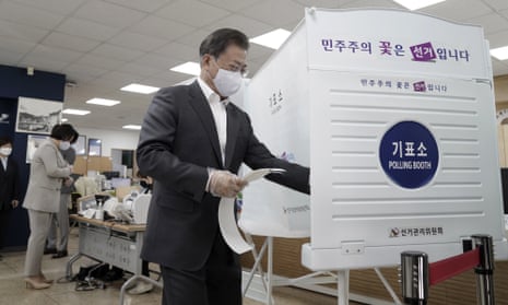 The South Korean president, Moon Jae-in, enters a voting booth in Seoul on 10 April. 