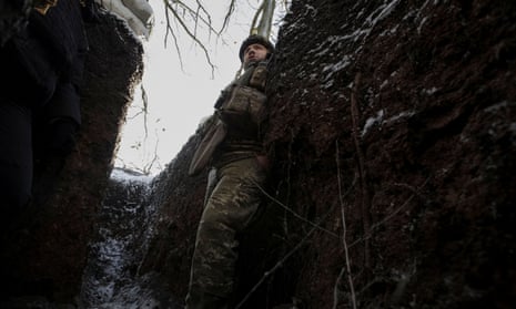 A Ukrainian serviceman is seen in a trench at a frontline in the Donetsk region.