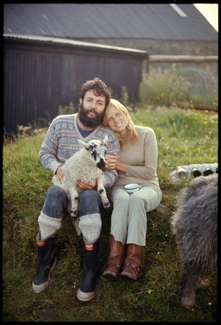Paul and Linda, 1970. They are sat next to each other while Paul holds a lamb on his lap